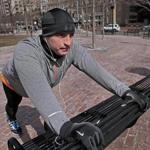 Peter Riddle stretched for a run along the Rose Fitzgerald Kennedy Greenway. He helped rescue a victim who lost a leg in the Boston Marathon bombings last year and struggles with post-traumatic stress disorder.